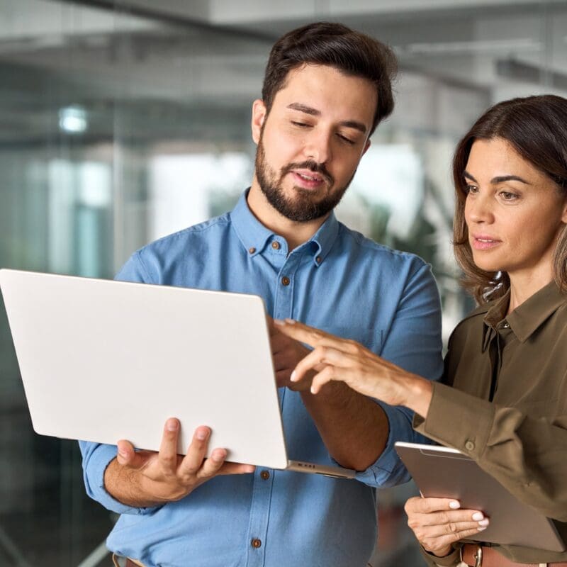 IT leader reviewing agile automation strategy with team across multiple screens in a modern workspace